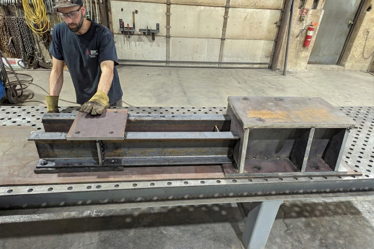 A man working on a large steel beam