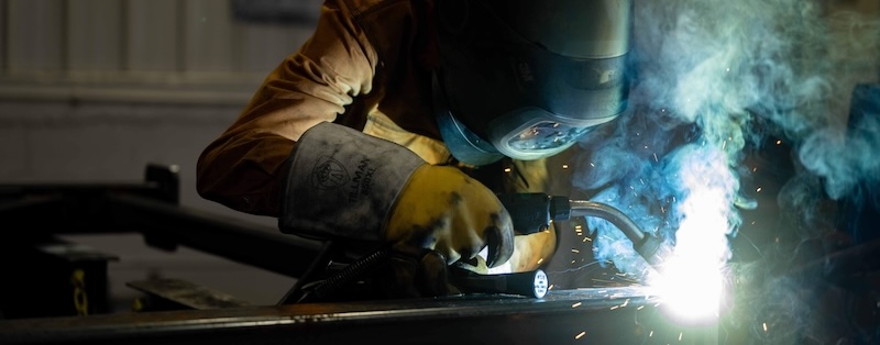 An up-close photo of a man welding